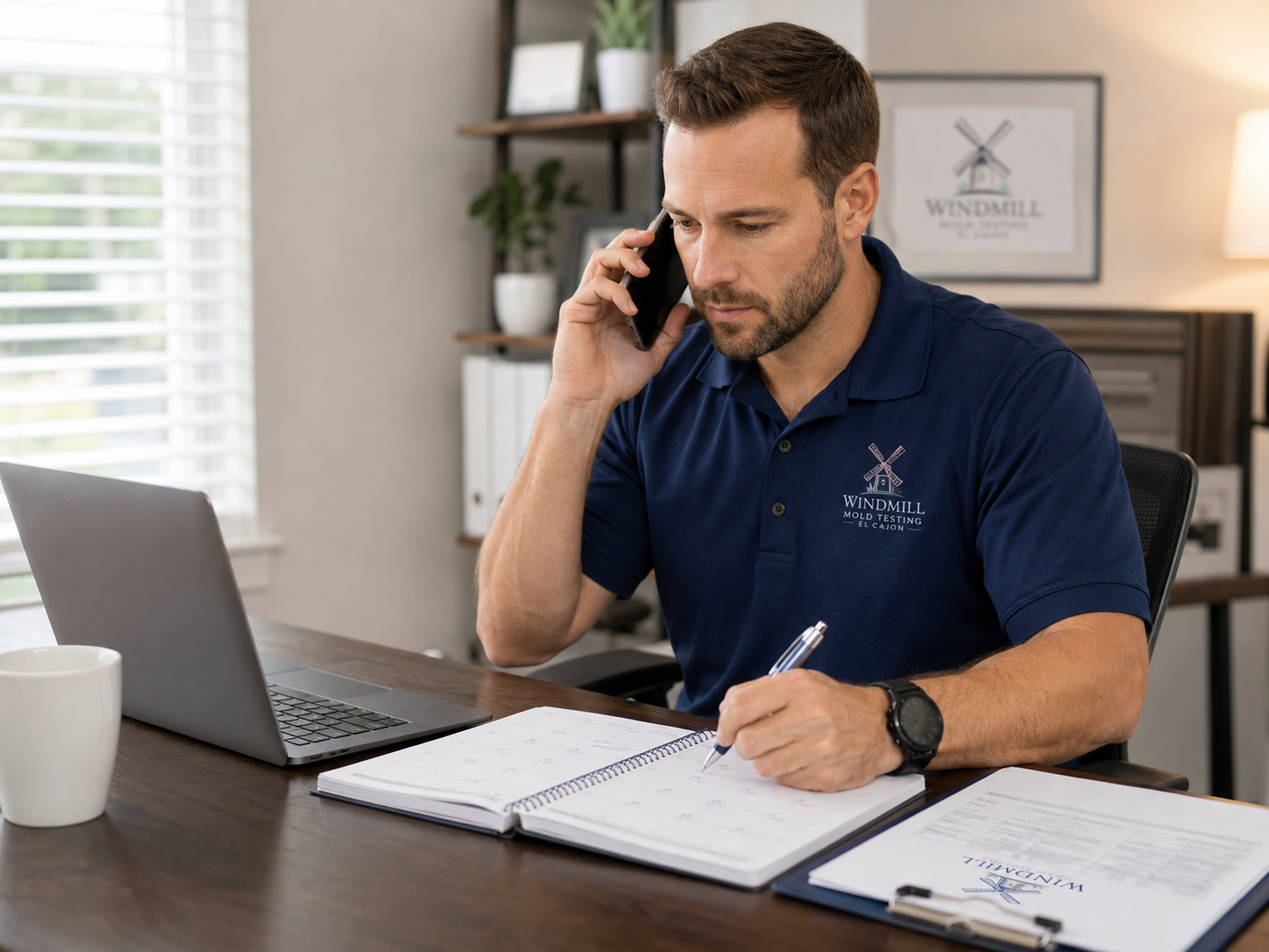 Windmill Mold Testing team member scheduling a mold inspection call at a desk